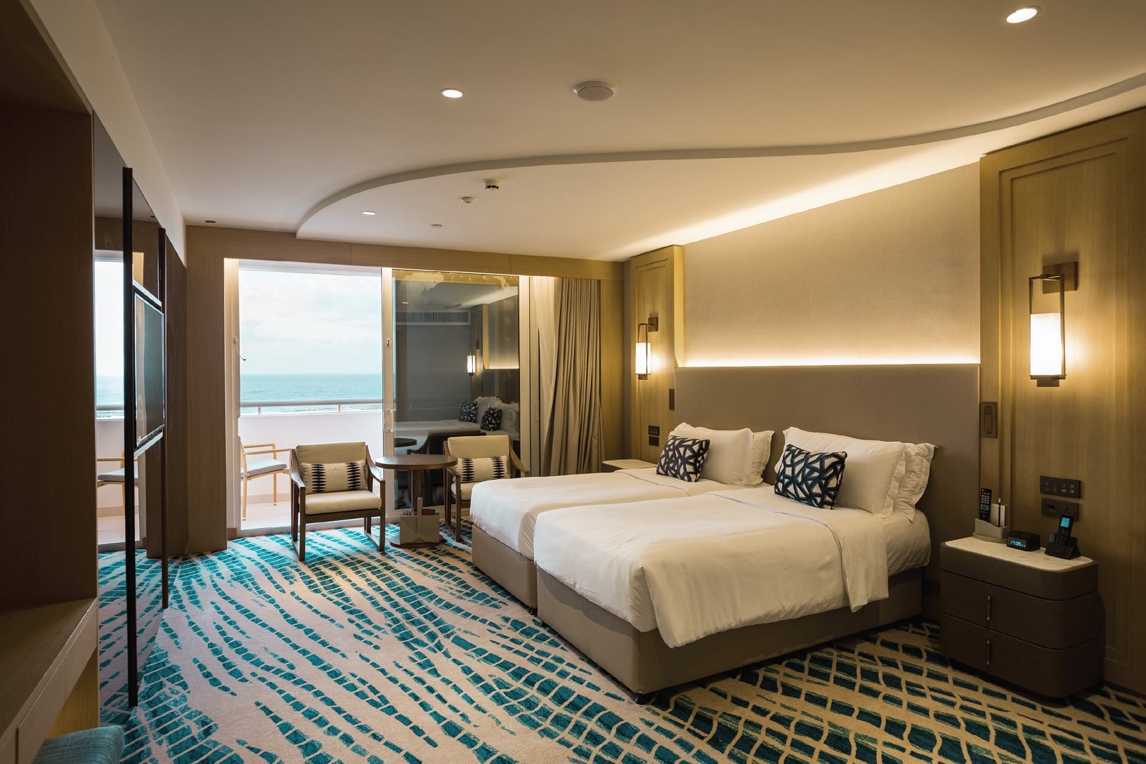 Modern hotel bedroom with sea view.
